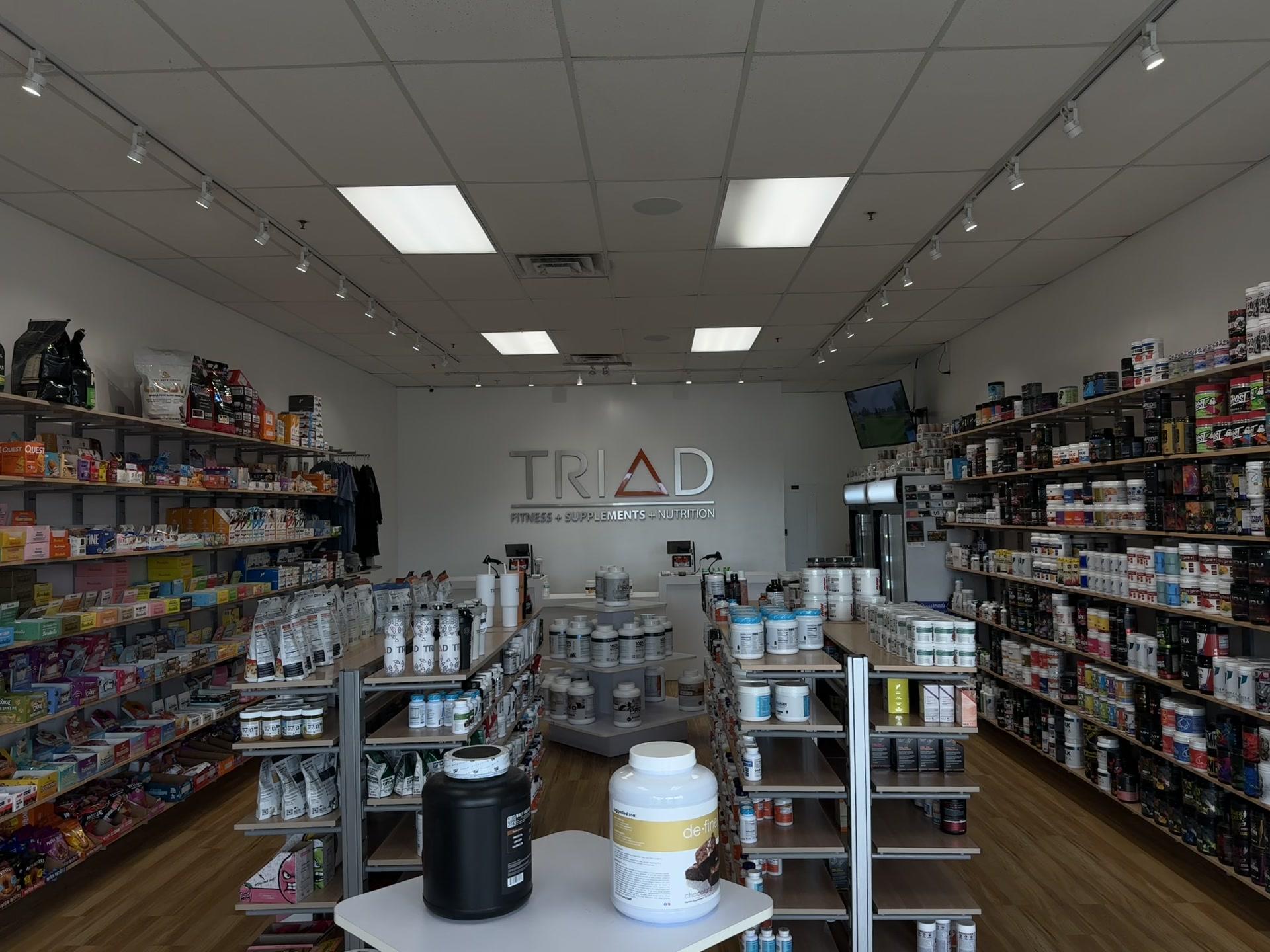 Inside a TRIAD store: supplement shelves on both walls